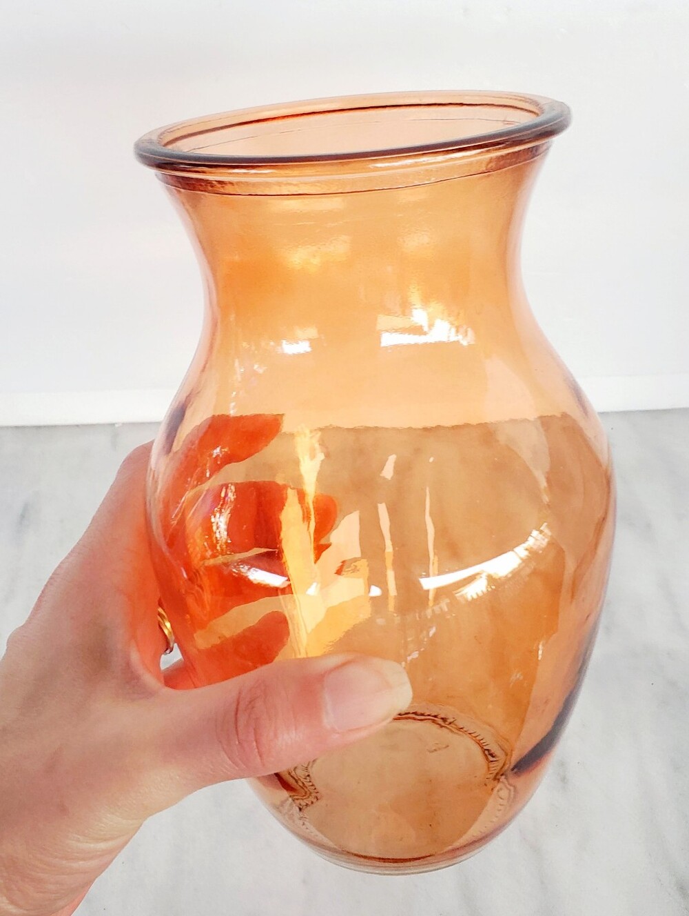 Vintage-style vase crafted from amber-colored glass and features a flared mouth